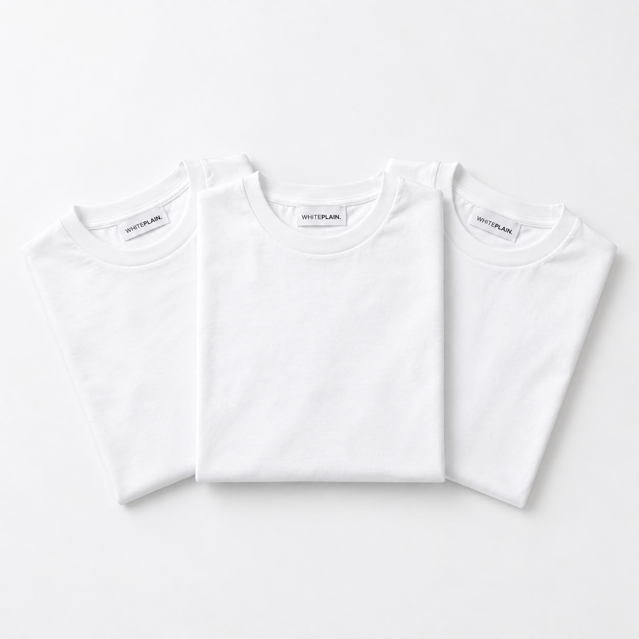 Three folded WHITEPLAIN white T-shirts